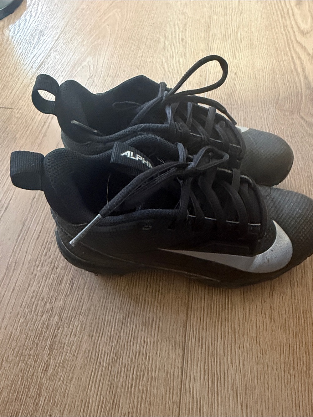 Nike kid’s Black Athletic Cleats with Silver Swoosh